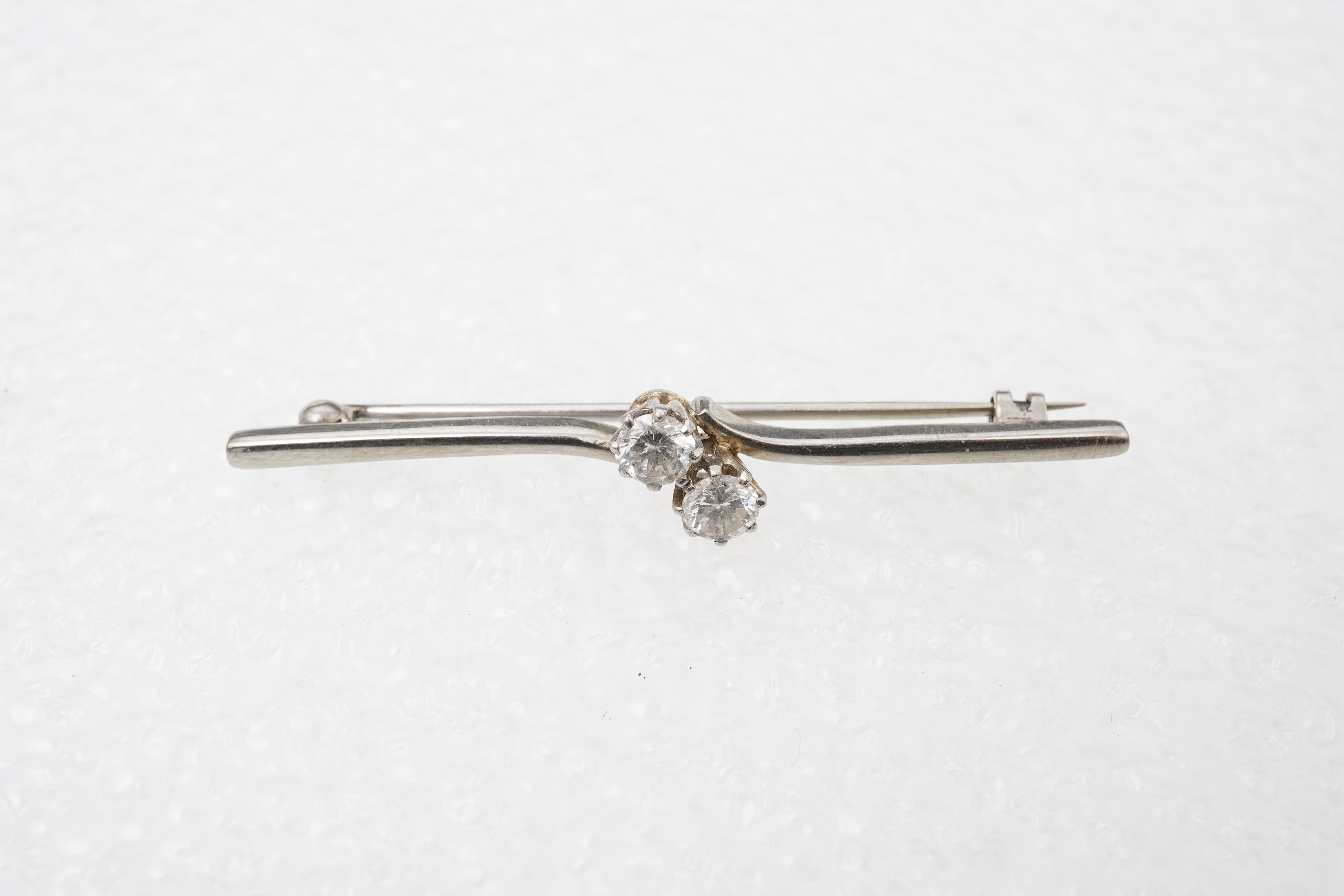 A diamond bar brooch